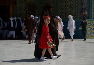 Мазари-Шариф, Афганистан. Девочка с матерью идут через двор Голубой мечети (святыни Хазрат Али)