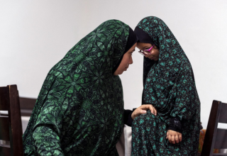 Кобари с одной из ее младших дочерей, которая научилась молиться за два дня до начала Рамадана