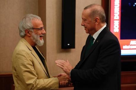 Recep Tayyip Erdogan (R) shakes hands with British singer-songwriter Yusuf Islam, formerly known as Cat Stevens (L), on 31 October 2019